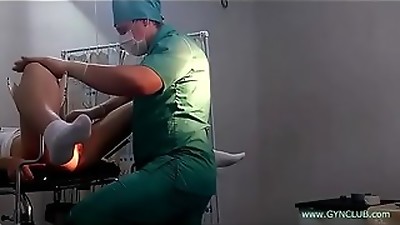 A girl in white socks on a gynecological chair